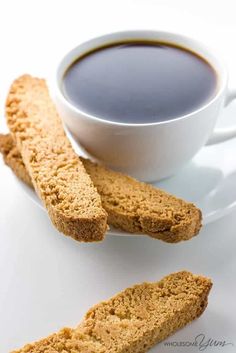 two pieces of biscuit next to a cup of coffee