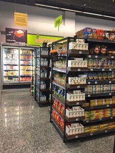 an aisle in a grocery store filled with lots of food and drinks on the shelves