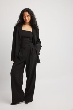 These suit pants feature a high waist fit and a wide leg. They have a pleated design and belt loops. Our suit pants feature side slant pockets and a concealed zipper, hook and button closure. Sleek Black Wide-leg Pantsuit, Sleek Tailored Wide Leg Pants For Night Out, Black Wide Leg Pantsuit For Formal Occasions, Sleek Wide Leg Pantsuit For Business, Black Wide-leg Pantsuit For Formal Occasions, Formal Solid Color Wide-leg Pantsuit, Sleek Wide-leg Pantsuit For Business, High Waist Pantsuit With Belt Loops For Office, Formal Wide-leg Pantsuit In A Solid Color