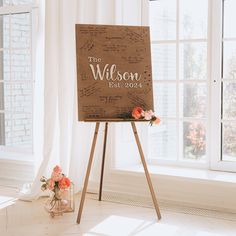 a wooden easel with the name of someone's wedding date written on it