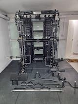 there are many racks in the room with wires attached to each rack and two doors open