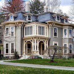 an old victorian style house with many windows