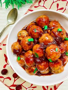 sweet and sour meatballs with cranberry sauce in a white bowl on a table