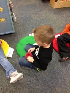 three children sitting on the floor playing with toys