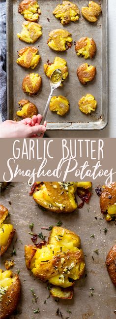 garlic butter smashed potatoes on a baking sheet with a hand holding a spoon over them