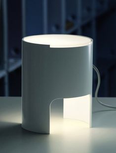 a white lamp sitting on top of a table