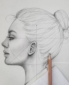 a pencil drawing of a woman's face with lines drawn on the side and behind her head