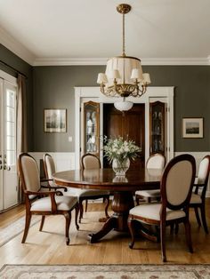 a dining room table with chairs and a chandelier