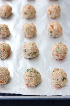 several balls of food sitting on top of a baking sheet