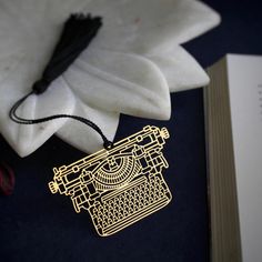 a book with an ornament sitting on top of it next to a flower