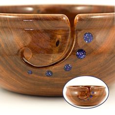 a wooden bowl with blue and white dots on the inside is shown in front of it