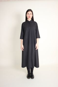 Elegant wool long maxi shirt dress  is a simple and classic autumn and winter dress.  This minimalist, modest dress is handmade from warm wool and is perfect for casual wear or for office, you will always look elegant and feel warm.  This fashionable, practical A-line dress with raglan cut sleeves and side seam pockets is very comfortable and easy to wear. You can wear it loose or with any belt you have for more defined shape.  DRESS DETAILS: - Fabric: 100% wool.  - Color: black grey stripes. ( You can choose a different color). Please note that actual colors may vary due to your computer monitor settings. - Wash & Care: recommended professional dry cleaning.  Hand wash in warm water (max 30-40 degrees), do not bleach, soak or tumble dry. Turn inside out before washing. Iron inside out on Winter Wool Dresses With Buttons, Classic A-line Shirt Dress For Fall, Classic Cotton Midi Dress For Fall, Wool Midi Dress For Spring Workwear, Spring Wool Midi Dress For Work, Spring Workwear Wool Midi Dress, Fall Midi-length Shirt Dress With Placket, Fall Midi Length Shirt Dress With Placket, Classic Collared Winter Dress