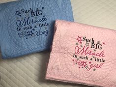 two pink and blue quilts with words on them