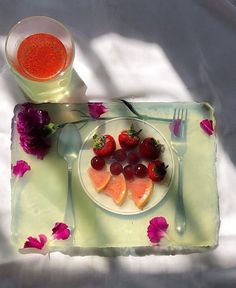 a white plate topped with fruit on top of a table