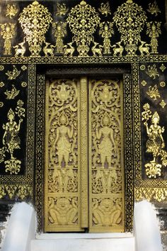 an ornate gold door with intricate carvings on it