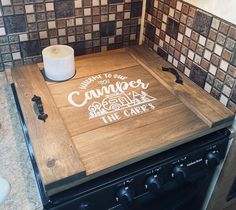 a wooden cutting board sitting on top of a stove