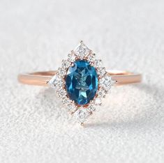 an oval blue and white diamond ring in rose gold