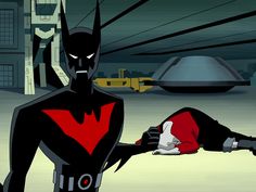 the animated batman is laying on the ground in front of an alien like creature with horns