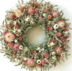 a wreath with pink and white flowers on it