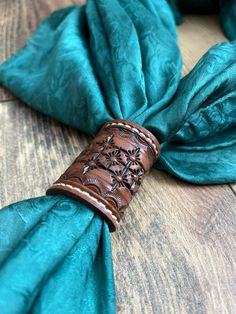 a close up of a tie on top of a wooden table with a blue cloth