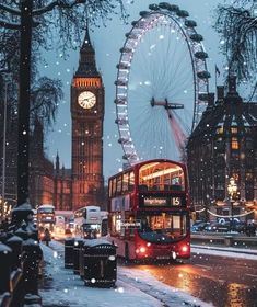 a red double decker bus driving down a snow covered street next to a clock tower