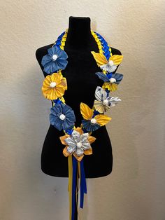 a black mannequin with blue, yellow and white flowers on it's neck