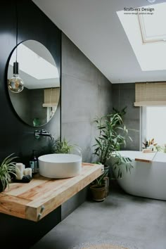 a bathroom with a sink, mirror and bathtub in the middle of the room