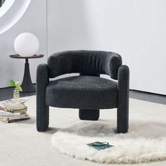 a black chair sitting on top of a white rug