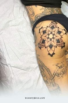 a woman laying on top of a bed covered in tattoos