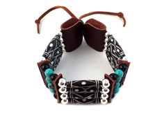 - Made from authentic buffalo bone hairpipe beads, 6 mm round beads, and genuine leather. - Necklace length: 11.75 inches long (without the leather ties). - Bracelet length: 8.5 inches (not including the adjustable ties). - Traditional tribal bone choker and bracelet set. - Handmade in the United States. Black Bohemian Leather Bracelet With Round Beads, Bohemian Black Leather Bracelet With Round Beads, Bone Choker, Necklace And Bracelet Set, Necklace And Bracelet, Leather Necklace, Necklace Length, Necklace Bracelet, Bracelet Set