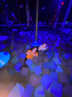 a woman laying on the ground surrounded by blue lights