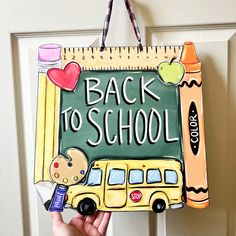 a hand holding up a back to school sign