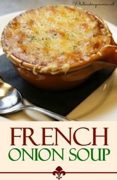 the cover of french onion soup on a plate with spoons