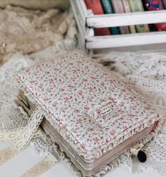 a book sitting on top of a white doily next to a stack of books