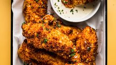 fried chicken wings with dipping sauce on a tray