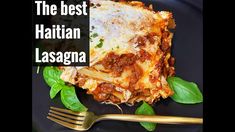 the best italian lasagna with basil leaves and gold fork on a black plate