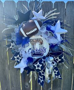 a football wreath on top of a wooden fence