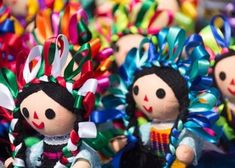 two dolls are dressed in different colors and patterns