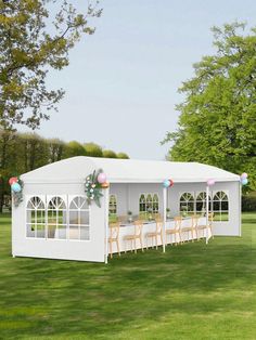 a large white tent with tables and chairs