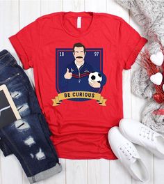 This "Be Curious" design is the perfect, fun Ted Lasso shirt for anyone that loves sports and Ted Lasso! Ted Lasso Shirt, Ugly Christmas Sweater Couples, Ted Lasso, Sports Soccer, Be Curious, Christmas Sweater Party, Ugly Christmas Sweater Party, Football Funny, Perfect Couple