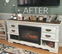 a white entertainment center with pictures on it and a fire place in front of the fireplace