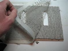 a person is working on a piece of paper with holes in the middle and one hole missing