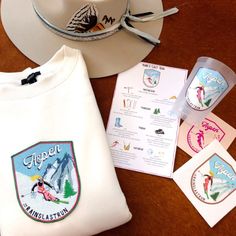 a hat, t - shirt, and other items are on a table with stickers