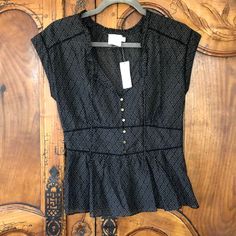 Anthropologie Hd In Paris Merce Dotted Peplum Top Size 4. Never Worn. Black With Small White Polka Dots Half Button Front Key Hole Front Tie On The Neckline Fitted Than Flares To A Peplum Side Zipper Cap Sleeves Semi Sheer - Need To Wear A Tank Underneath Casual Fitted Swiss Dot Blouse, Fitted Casual Tops With Swiss Dot Detail, Casual Fitted Swiss Dot Tops, Fitted Swiss Dot Casual Tops, Fitted Swiss Dot Tops For Summer, Fitted Swiss Dot Top With Short Sleeves, Fitted Swiss Dot Blouse For Work, Elegant Fitted Polka Dot Top, Elegant V-neck Swiss Dot Top