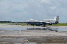 a large air plane sitting on top of an airport tarmac with it's landing gear down