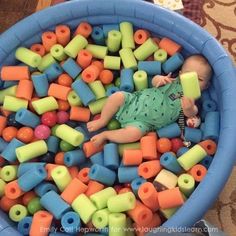 baby and toddler play space using cut pool noodles and plastic balls with text overlay