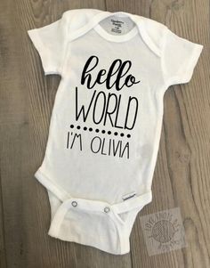 "Hello World I'm _______" Custom made Bodysuit This design is made with heat transfer vinyl. These are machine washable. Wash in cold water and lay flat to dry. Do not Dry Clean. The bodysuit is available in different sizes. Use the menu to select the necessary size based off the size chart. GERBER® ONESIE® tends to run small, so if you are hesitating on size, I recommend buying the next size up. All sales of custom items are final.  Please double check that you have provided us with all necessa Custom Name White Cotton Onesie, Customizable Black Cotton Onesie, Cricut Clothing, Cut Recipe, Custom Baby Onesies, Newborn Bodysuit, Cricut Baby, Personalized Onesie, Cricut Air