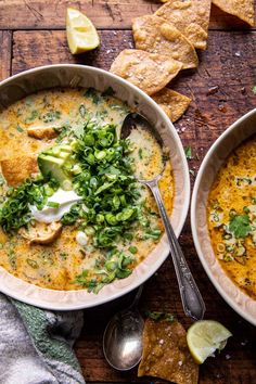 two bowls of soup with tortilla chips on the side