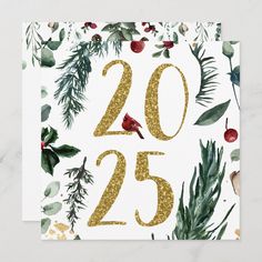 a white card with gold glitter numbers and evergreen leaves on it, which reads 205