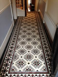 the hallway is decorated with black and white tiles